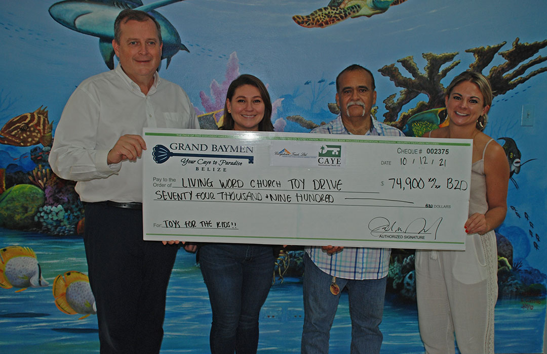 Ambassador Joel Nagel, Gladys Urbina, Pastor Ian Zaldivar and Rahcel Jensen holding cheque for 2021 Toy Drive Christmas event in Belize